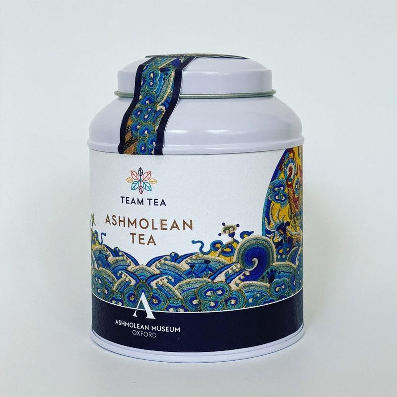 An isometric view of the Ashmolean Tea Caddy showing the highly decorative label with swirling embroidered waves.