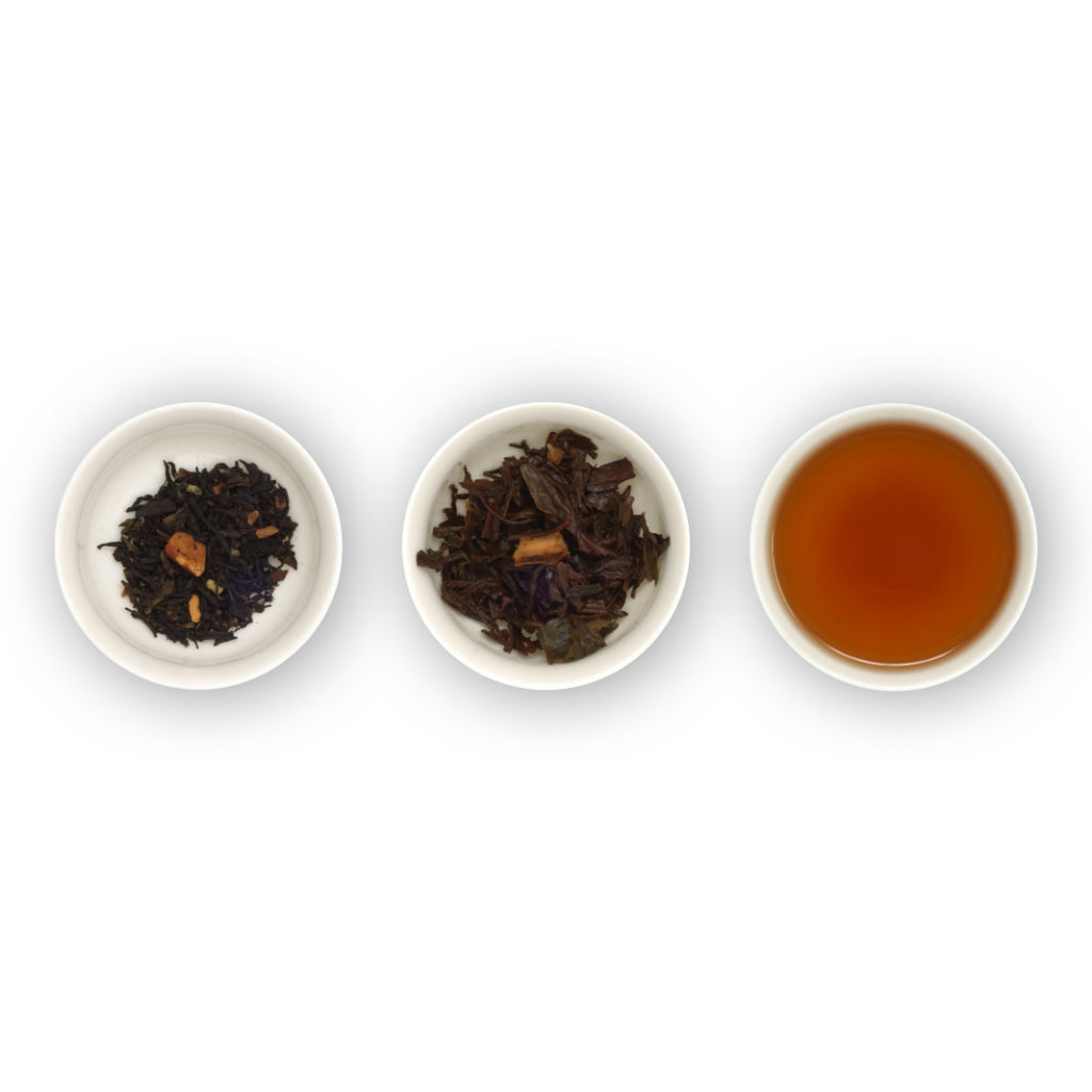 Three white bowls containing Christmas spiced tea leaves and pieces, and the resulting brewed tea