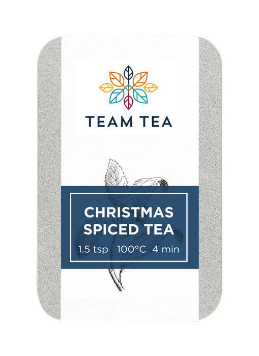 A silver metal tin against a white background. The tin is labelled Christmas Spiced tea and contains loose-leaf tea leaves.