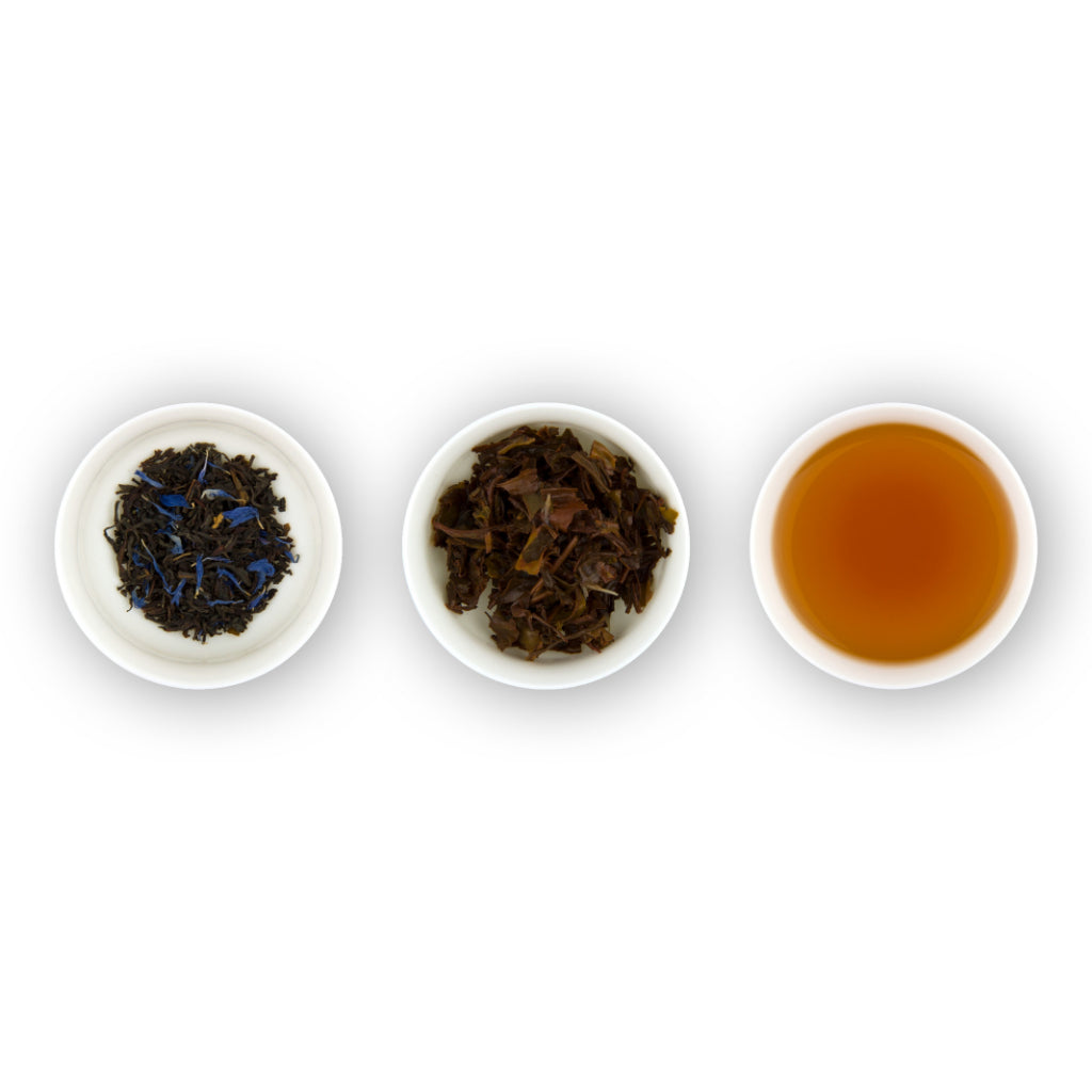 Three circular bowls arranged in a row, with the left bowl showing dry black tea leaves with blue cornflower petals, the middle bowl showing loose tea leaves, and the right bowl showing brewed tea in a cup.
