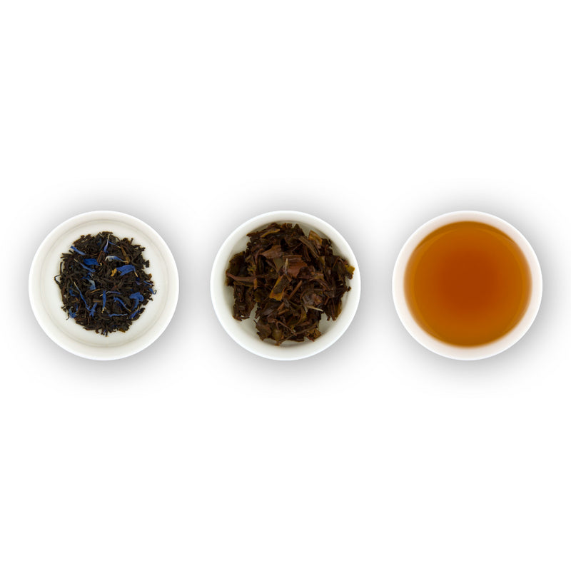 Three circular bowls with samples of Earl Grey tea. The first bowl shows dry loose black tea leaves with blue flower petals, the second bowl shows the tea leaves after brewing, and the third bowl shows the brewed tea liquid.