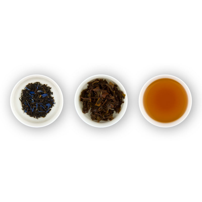 Three circular bowls arranged in a row, with the left bowl showing dry black tea leaves with blue cornflower petals, the middle bowl showing loose tea leaves, and the right bowl showing brewed tea in a cup.