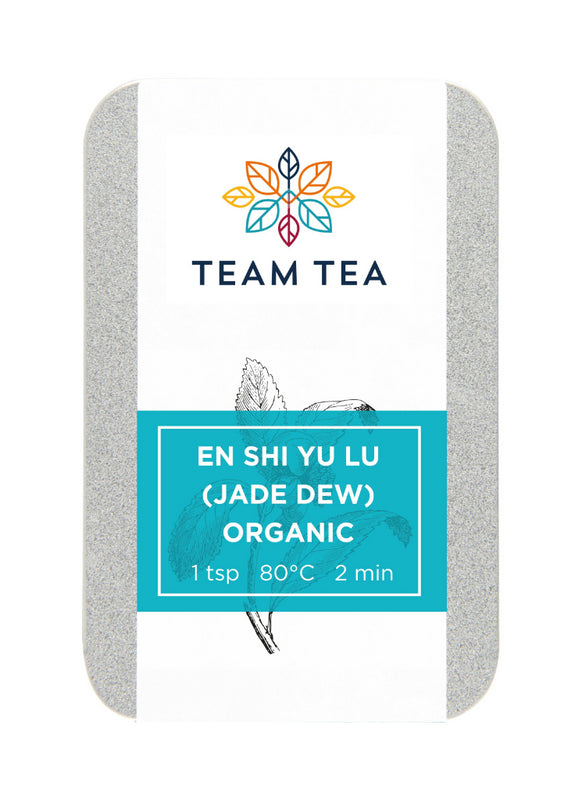 A metal tin on a white back ground. The tin contains loose-leaf green tea from China. There is a turquoise label and brand logo