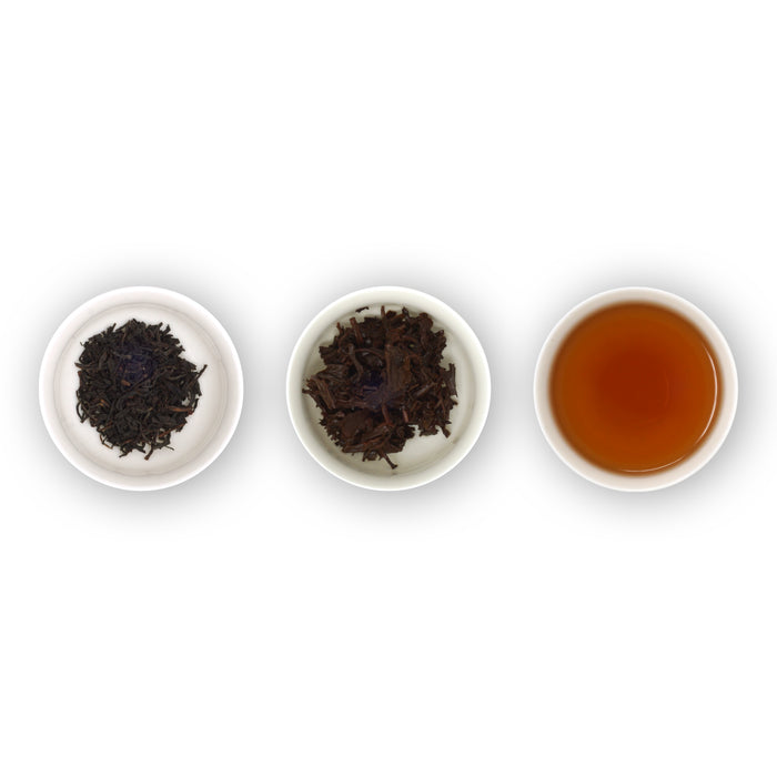 Three white bowls containing loose tea leaves and brewed tea, arranged in a row on a white background.
