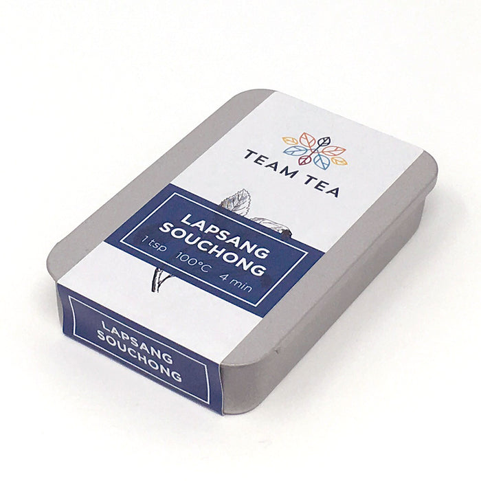 A metal tin with sliding lid and branded paper label. The tin contains Lapsang Souchong loose black tea