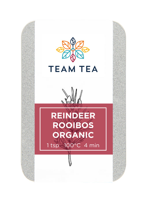 A silver metal tin on a white background. There is a red label and botanical sketch of the rooibos plant.