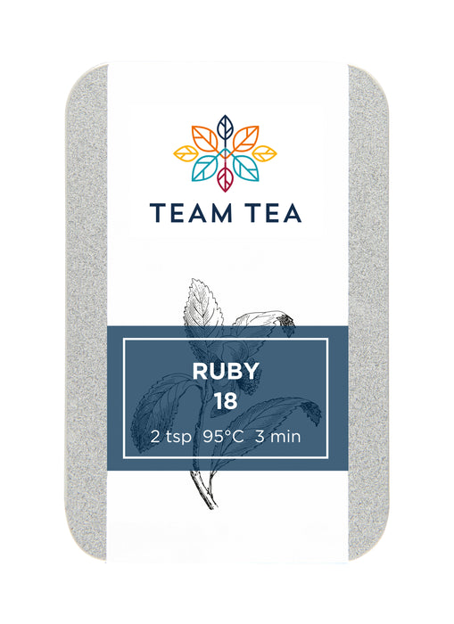 A metal tin with sliding lid containing loose-leaf black tea. The tin has a navy blue label with text Ruby 18.