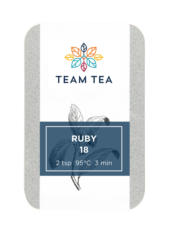A metal tin with sliding lid containing loose-leaf black tea. The tin has a navy blue label with text Ruby 18.