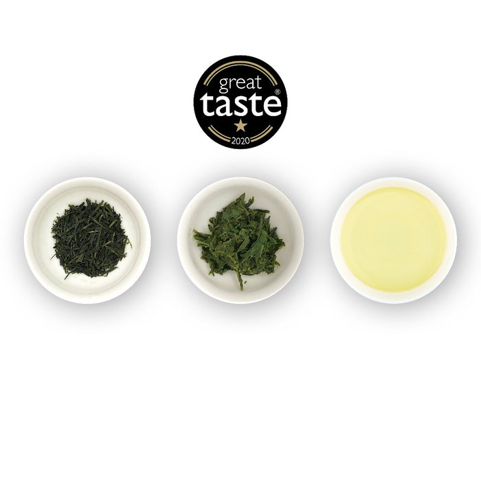 Three white bowls containing loose leaf green tea, with a logo of 'great taste' at the top center, and a bowl of brewed tea on the right.