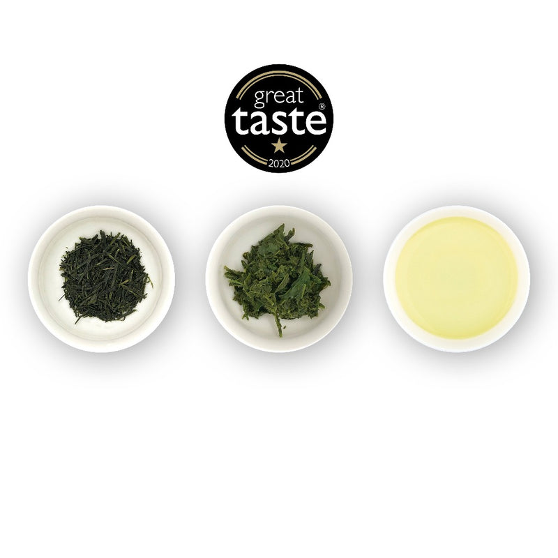 Three white bowls containing loose leaf green tea, with a logo of 'great taste' at the top center, and a bowl of brewed tea on the right.