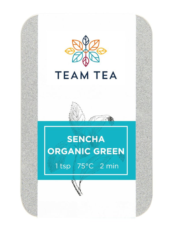 A silver metal tin of Organic green tea from Japan. The tin has a turquoise label and botanical sketch of a tea plant.