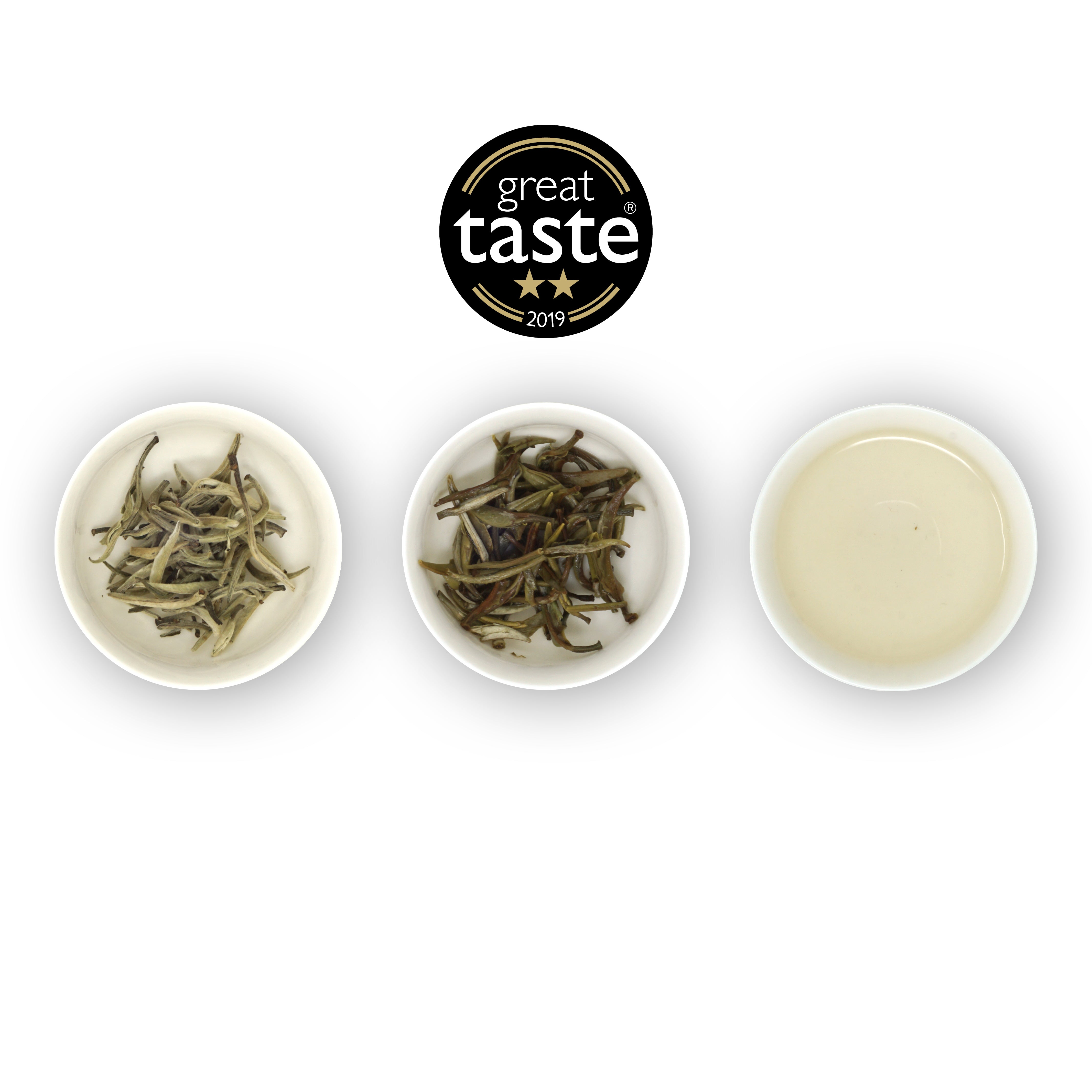 Three circular bowls with samples of Yin Zhen Silver Needle tea. The first bowl shows dried silver needle buds, the second bowl shows the tea leaves after brewing, and the third bowl shows the brewed tea liquid. Above is the Great Taste Awards logo