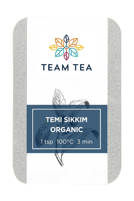 A metal slide tin containing loose-leaf tea labelled Temi Sikkim Organic on a white background