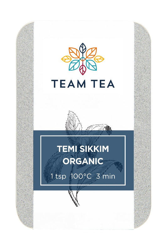 A metal slide tin containing loose-leaf tea labelled Temi Sikkim Organic on a white background