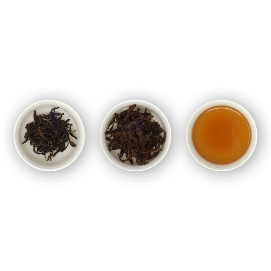 Three circular bowls arranged in a row, with the left bowl showing dried black tea leaves, the middle bowl showing brewed black tea leaves, and the right bowl showing the brewed tea in a cup.