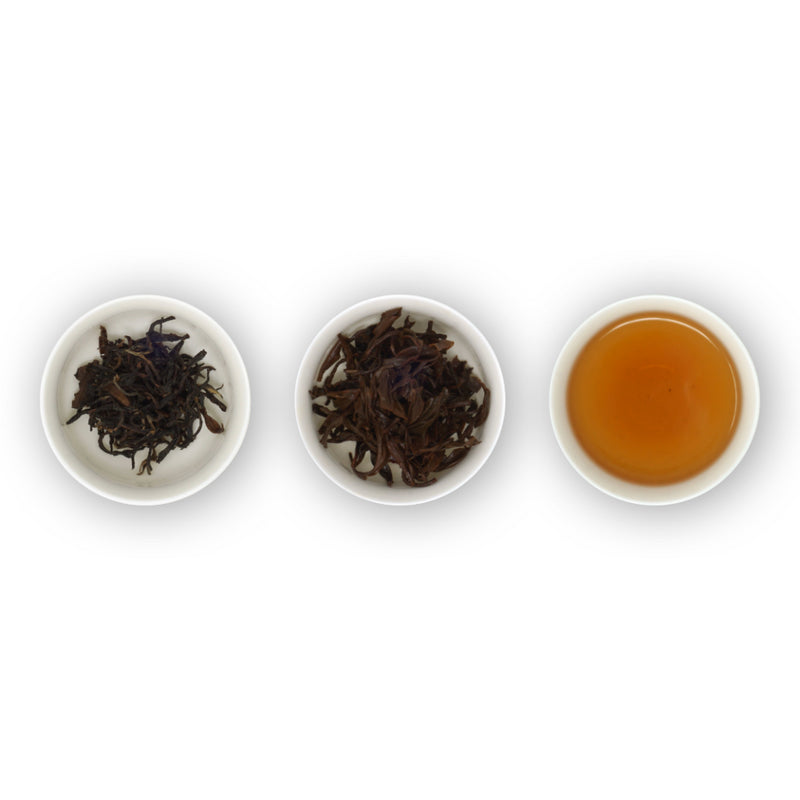 Three circular bowls arranged in a row, with the left bowl showing dried black tea leaves, the middle bowl showing brewed black tea leaves, and the right bowl showing the brewed tea in a cup.