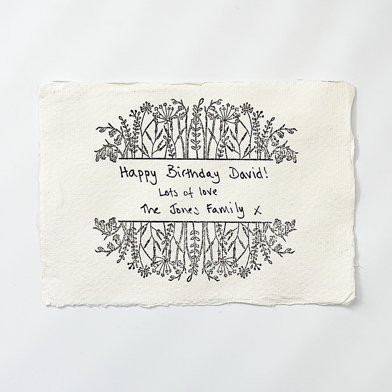 Handwritten birthday card with decorative elements on a white background