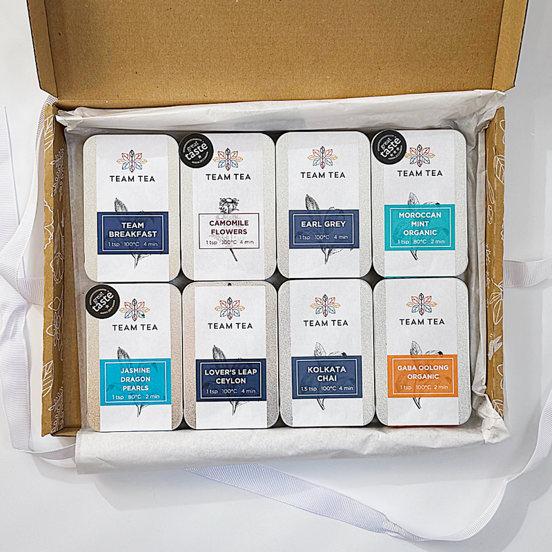 Box of Team Tea slide tins on a white background