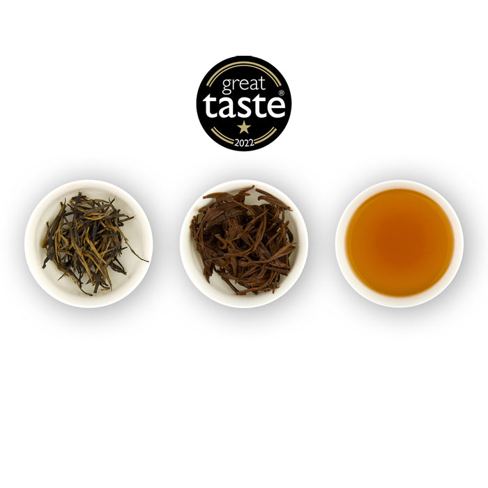 Three white bowls with tea leaves and a brewed tea, featuring the Great Taste 2022 logo.