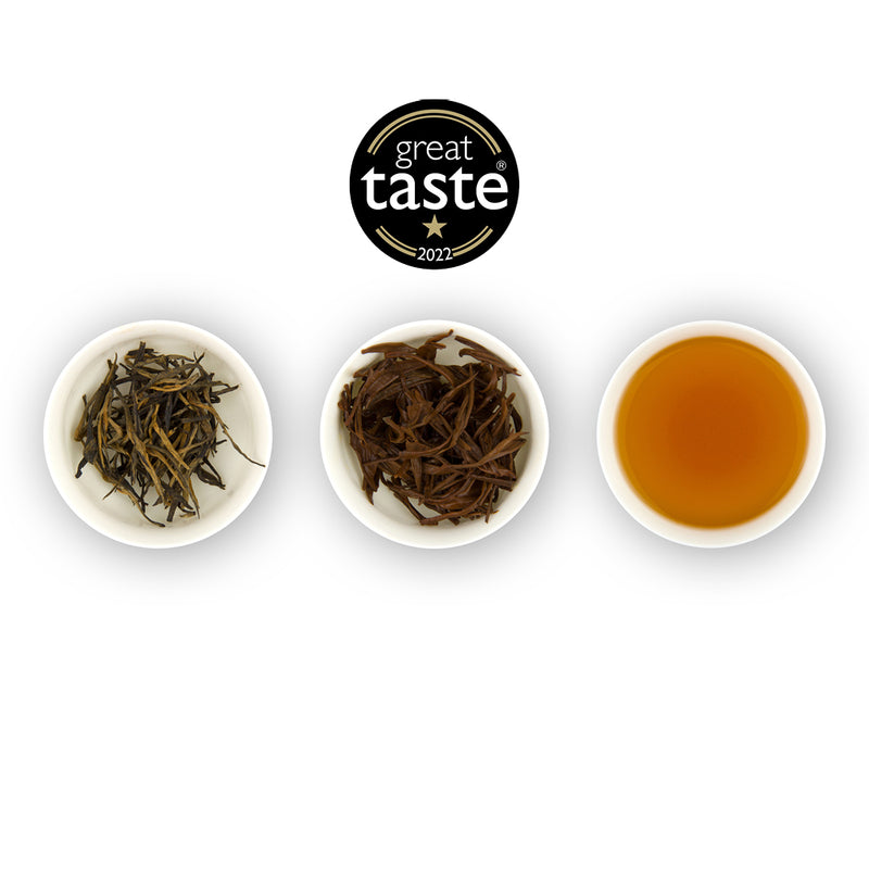Three white bowls with tea leaves and a brewed tea, featuring the Great Taste 2022 logo.