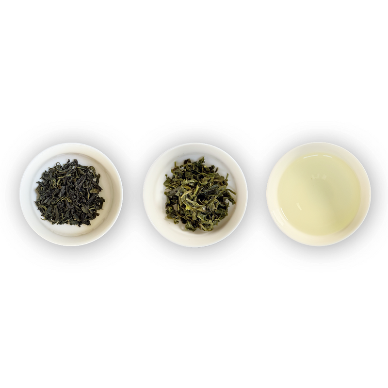 Yeongam Jungseon organic Korean green tea shown in three white ramekins: dry leaf on the left, infused wet leaf in the middle, and the pale yellow-green brewed tea on the right.
